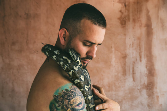 Close up of man holding snake