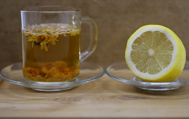 tea in a glass, lemon on a plate