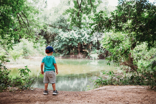 Young boy looking at water near Barton Springs