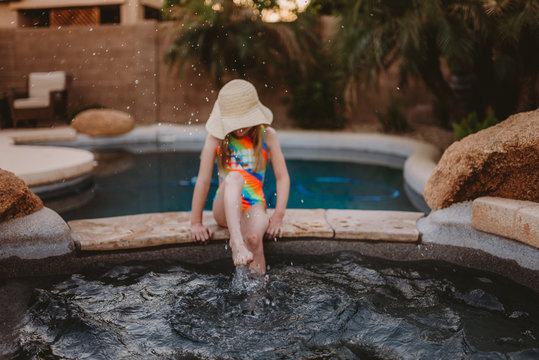 Girl Splashing Water From Pool