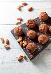 Delicious homemade energy balls with dried apricots, dates, prunes, walnuts, almonds and cashews in coconut and cocoa. Vegan and vegetarian raw snack or meal.