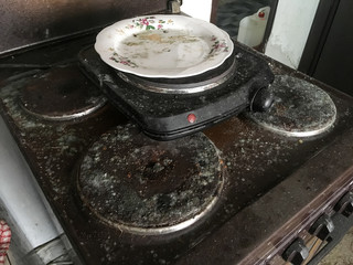 A detail picture of the old, unused, dirty and moldy oven. 