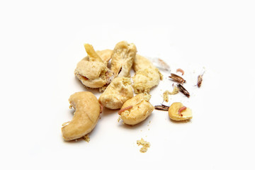 A picture of cashew nuts infested with caterpillars and butterflies of the meal moth. Isolated on a white background. 