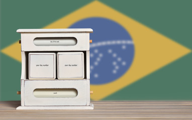 Wooden retro calendar with free space for a date on the background of the flag of Brazil. Template for writing the dates of the national holidays of Brazil with free text space