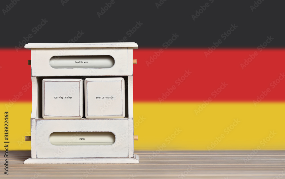 Poster wooden retro calendar with free space for a date on the background of the flag of germany. template 