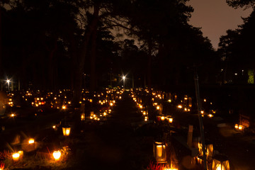 Christmas night at the Hietaniemi cemetery in Helsinki with Christmas lights, lanterns and candles that are traditionally lit in the cemetery on Christmas night in Finland.