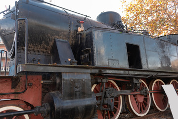 Fototapeta na wymiar old steam locomotive on rail on display