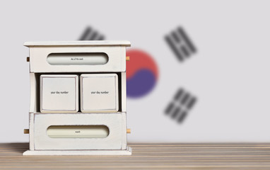 Wooden retro calendar with free space for a date on the background of the flag of South Korea. Template for writing dates of national holidays of South Korea with free text space.
