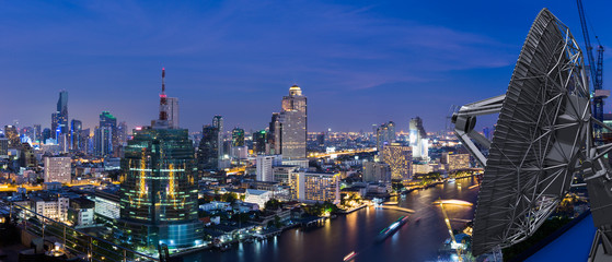 Telecommunication with 5G satellite dish on panorama night city background