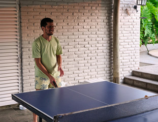 young man playing table tennis