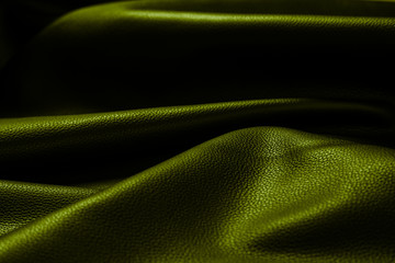 Texture cuir jaune vert sombre et noir plissé en ombre et lumière