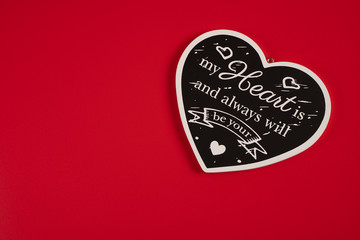 Heart black with the inscription-a Declaration of love, on a red background for Valentine's Day, wedding, birthday and other holidays, view from the top.