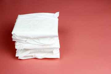 Naklejka premium A stack of daily pads. the concept of feminine Personal hygiene. Critical days, blood period, menstruation cycle.