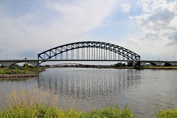 Old bridge of steel named Ijsselbrug over river IJssel to connect the province Gelderland to Overijssel at Zwolle in the Netherlands