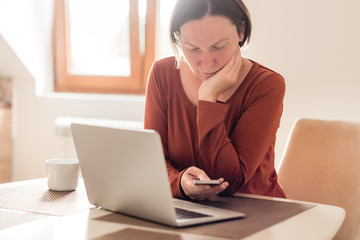 Woman telecommuting in home office interior