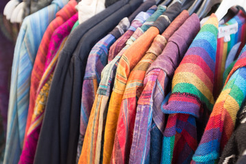Colourful hooded festival ponchos on a rack