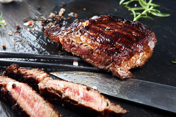 Barbecue Rib Eye Steak on Slate Slab - Dry Aged Wagyu Entrecote Steak and rosemary