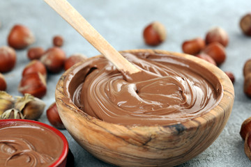 Homemade hazelnut spread in wooden bowl. Hazelnut Nougat cream with hazelnuts