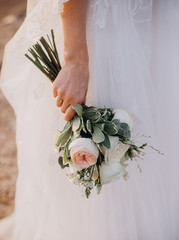 Bride holding wedding peonies bouquet