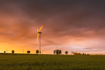 Fields with windmill for electric power production in Polish countryside. Europe