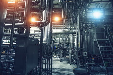Industrial background of beer factory or plant production with computerized automation process, stainless steel vats, reservoirs, pipelines, tubes and modern robotized technologies and electronics