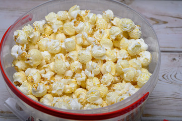 Plastic bucket with sweet popcorn ready to eat
