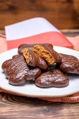 Tasty gingerbread glazed cookies from Torun, Poland and flag of Poland
