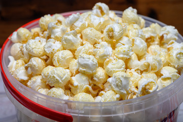 Plastic bucket with sweet popcorn ready to eat