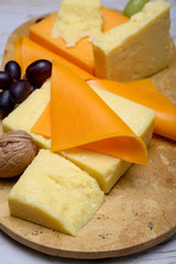 Cheese collection, blocks and slices of yellow and matured english cheddar cheese
