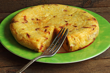 Tasty potato omelette on wood