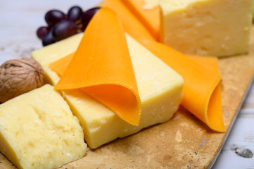 Cheese collection, blocks and slices of yellow and matured english cheddar cheese