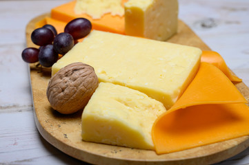 Cheese collection, blocks and slices of yellow and matured english cheddar cheese