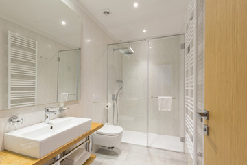 Interior of a luxury hotel bathroom with glass shower cabin
