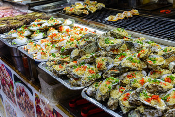 Chinese street food. Street trading. Chinese kinds of fresh seafood at an asian seafood market in Sanya, Hainan province, China. Inscription: name food.