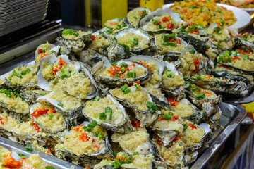 Chinese street food. Street trading. Chinese kinds of fresh seafood at an asian seafood market in Sanya, Hainan province, China. Inscription: name food.