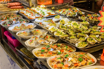 Chinese street food. Street trading. Chinese kinds of fresh seafood at an asian seafood market in Sanya, Hainan province, China. Inscription: name food.