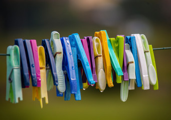 Colorful clothes pin clipped to an outdoor clothes or laundry line.