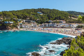 Crowded beach in Costa Brava (Catalonia, Spain). Summer holidays destination in Europe