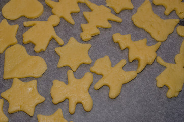 Dough cookies lie on a tray before baking