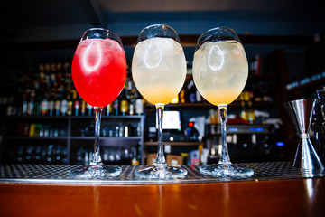 Bright alcoholic cocktails. Yellow and Red smoothies. Varieties of alcohol. Bar.