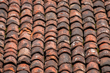 Old vintage red ceramic roof tiles closeup as background