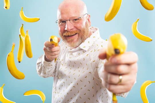 Bald Man Surrounded By Bananas