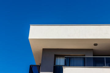 a nice looking architectural corner perspective shoot from a modern building - clear blue sky as background