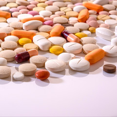 Fototapeta na wymiar Lots of different multicolored medicinal medicine drugs, pills, tablets, capsules. Pharmacy theme background, closeup, concept