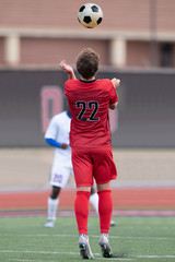 Fototapeta premium Young Soccer Players Making Athletic Plays During a Soccer Game