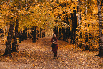 Curvy girl doing yoga in nature.