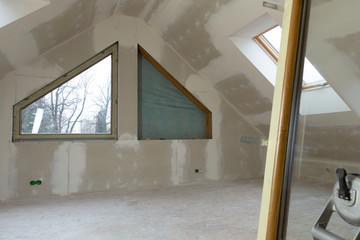PVC window instalation in a new insulated and filled dry wall attic.