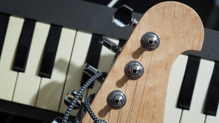 Guitar head and keyboard piano keys. Music, composer, group band concept