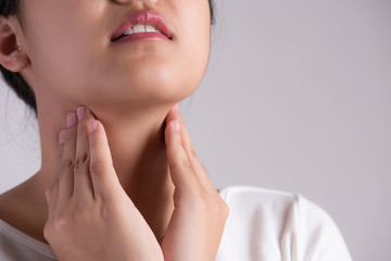 Sore Throat. Closeup Of Beautiful Young Woman Hand Touching Her Ill Neck. Healthcare and medical...