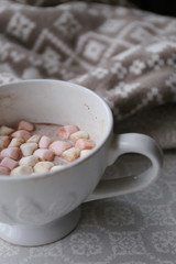 cocoa with marshmallows in a large white cup on the table